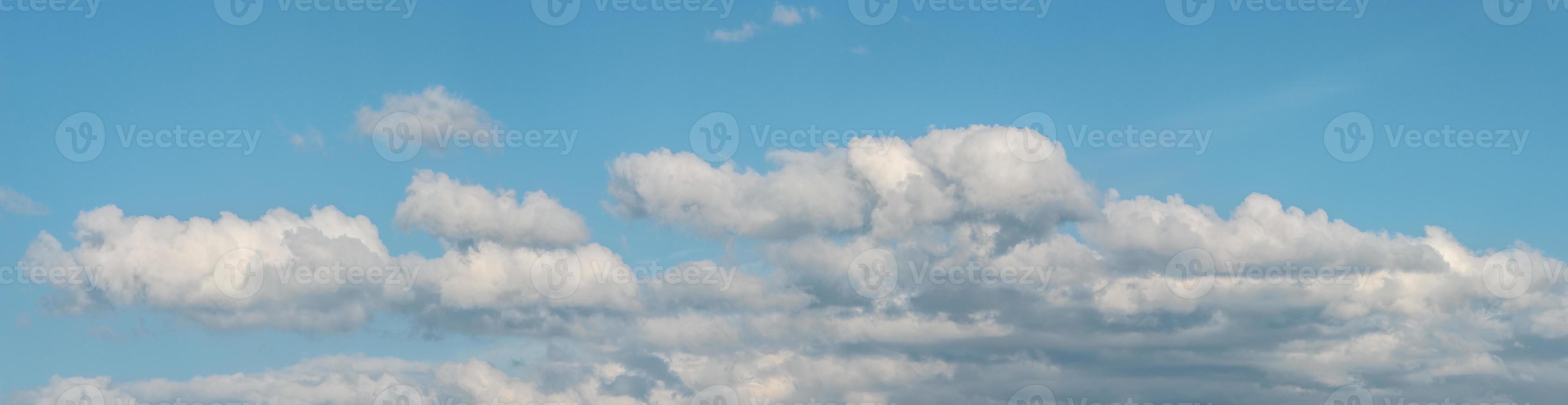 Banner with panoramic view over deep blue clean sky with illuminated clouds as a background. photo