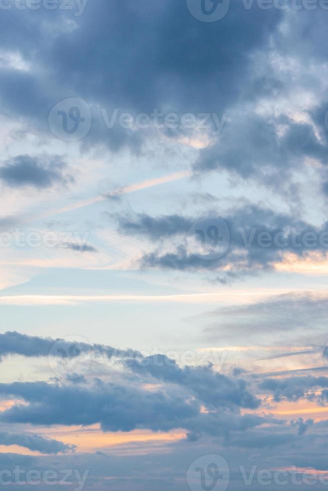 Cover page with deep blue sky with illuminated clouds at soft orange sunset as a background. photo