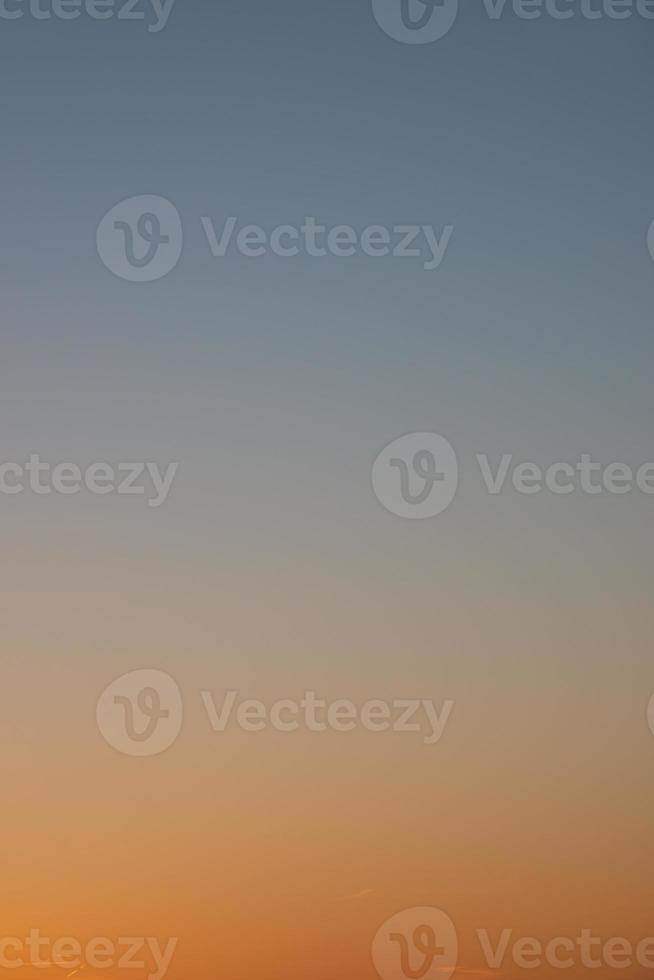 Cover page with clear gradient sky with no clouds at sunset colors as a background with copy space. photo