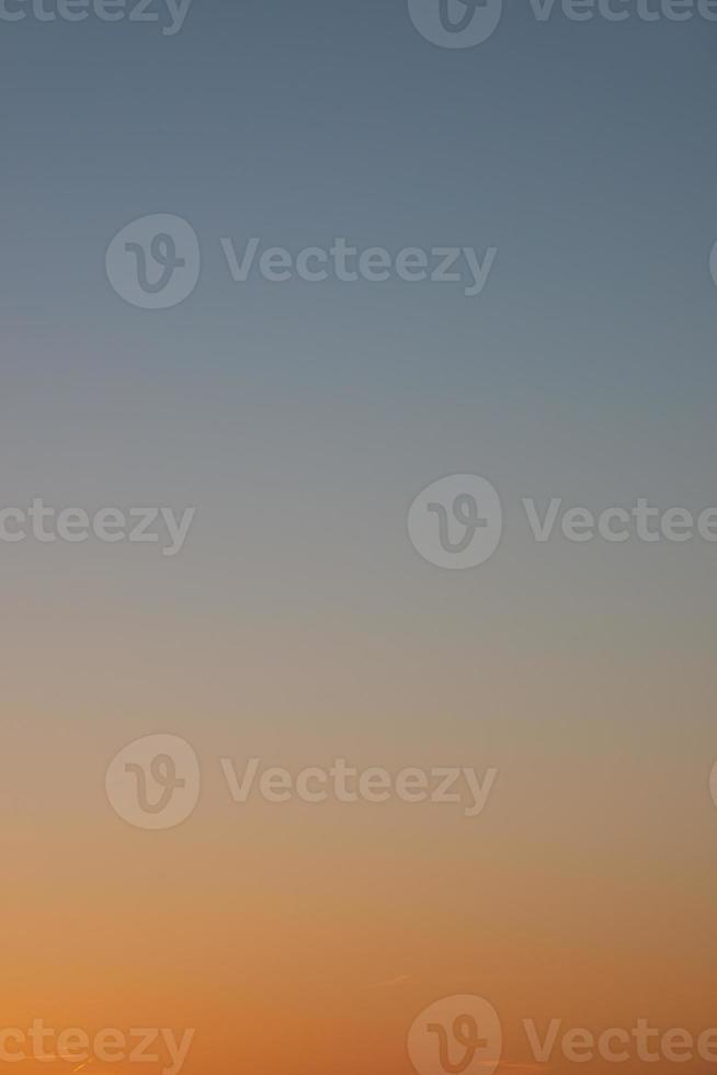 Cover page with clear gradient sky with no clouds at sunset colors as a background with copy space. photo