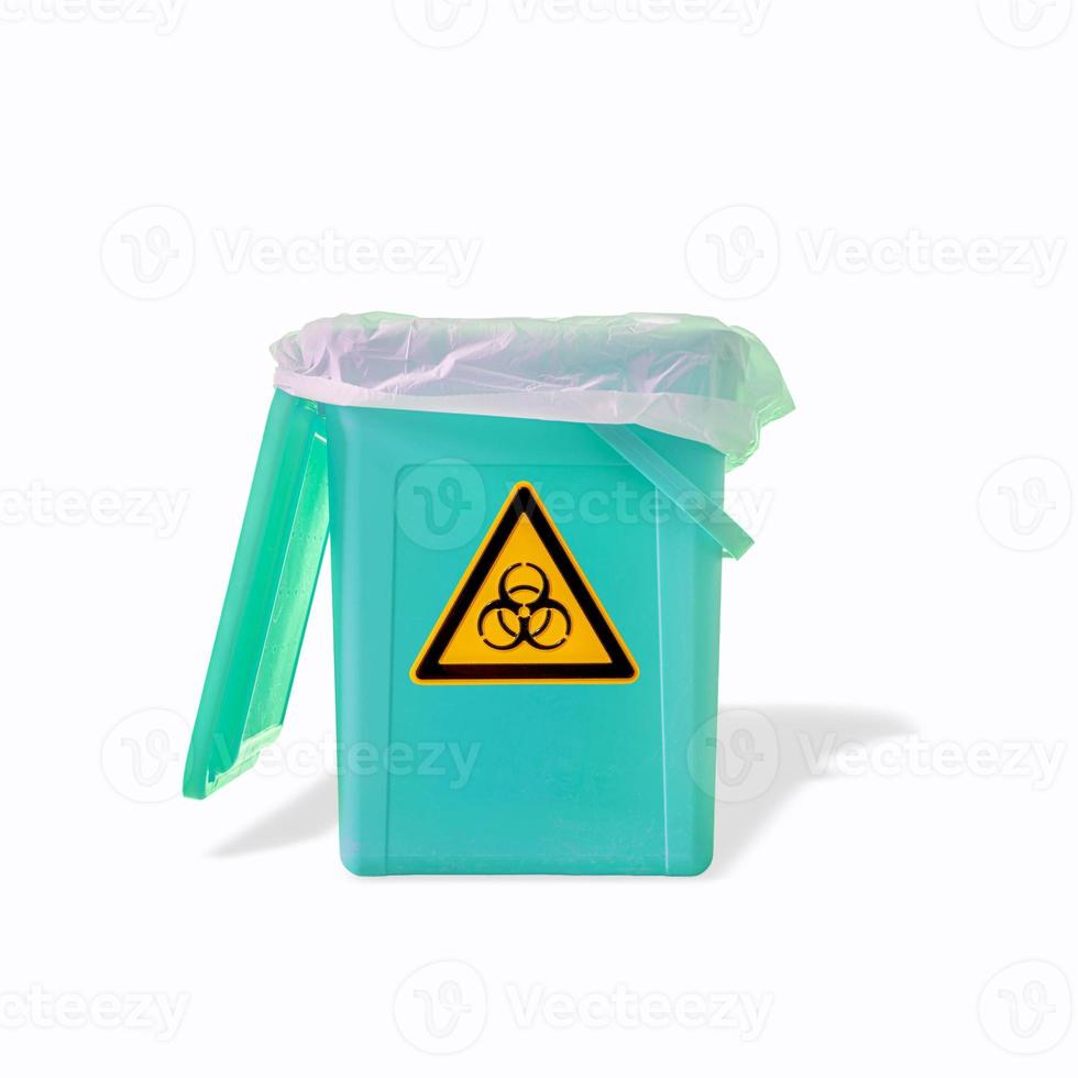 Fluorescent garbage trash bin with its shadows and radiation danger orange symbol isolated at white background. Concept of nuclear waste recycling and environment. photo