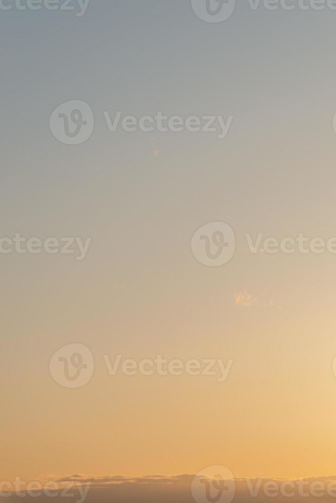 Cover page with gradient deep blue sky, illuminated clouds at bloody sunset as a background. photo