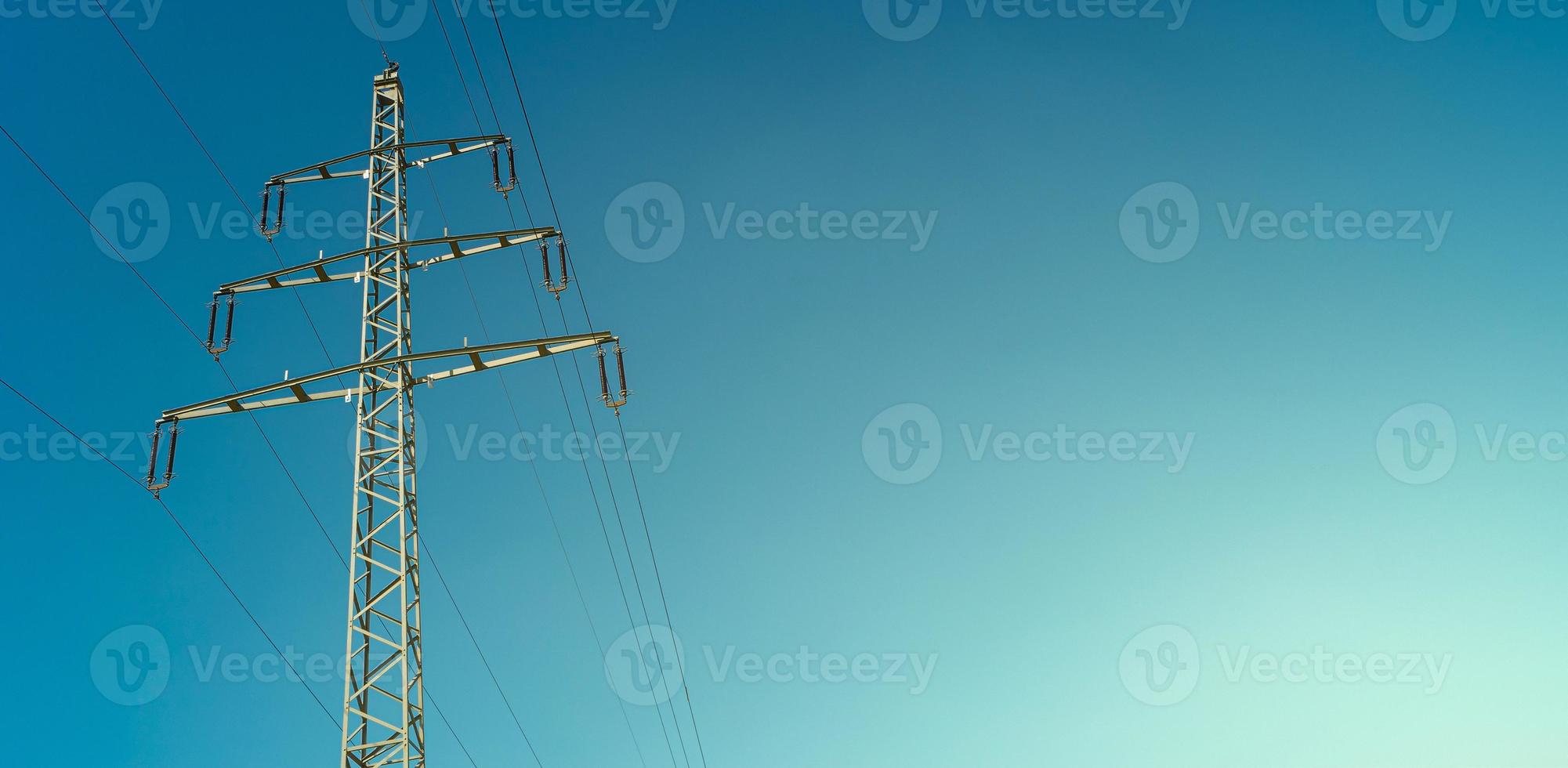 Modern high voltage electrical power towers and wire lines in Germany, in the blue gradient sunset sky and sunset colors and copy space. Concept of energy supply and energy crisis. photo
