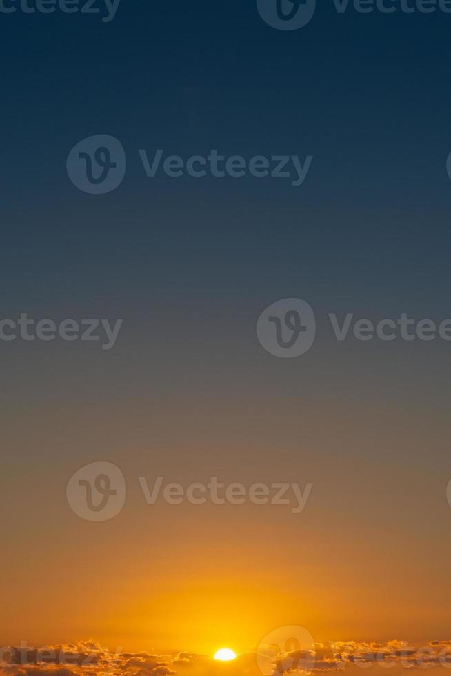 Cover page with gradient soft deep orange sky, illuminated clouds at bloody sunset as a background. photo