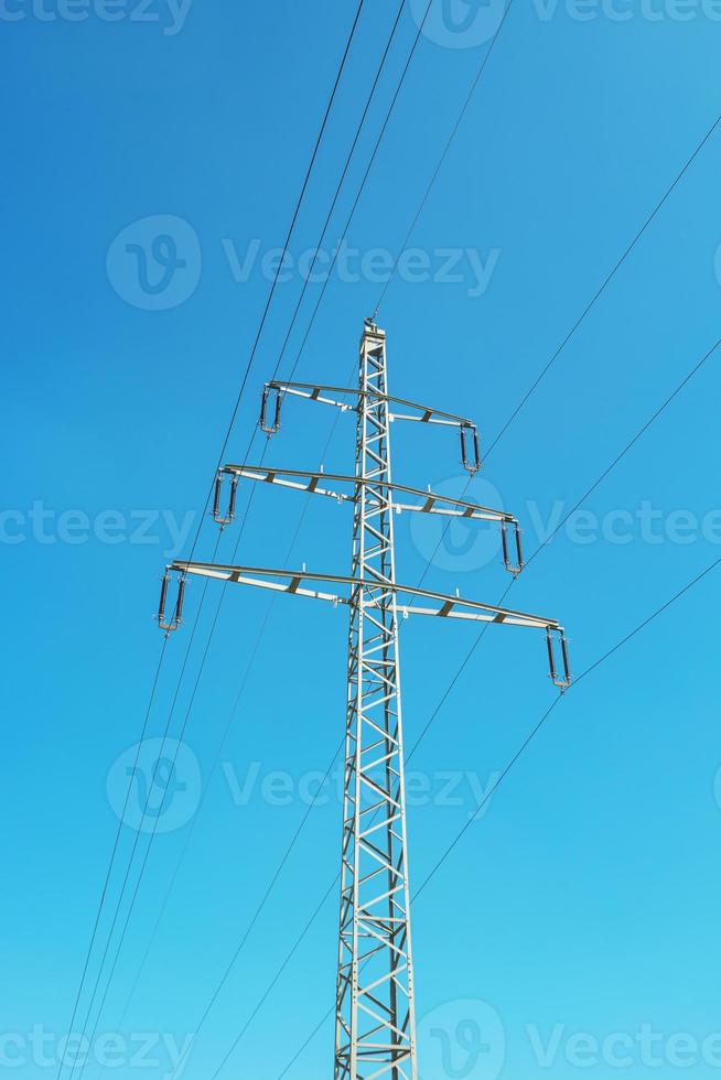 Cover page with modern high voltage electrical power towers and wire lines in Germany, in the blue sky and sunset colors and copy space. Concept of energy supply and energy crisis. photo