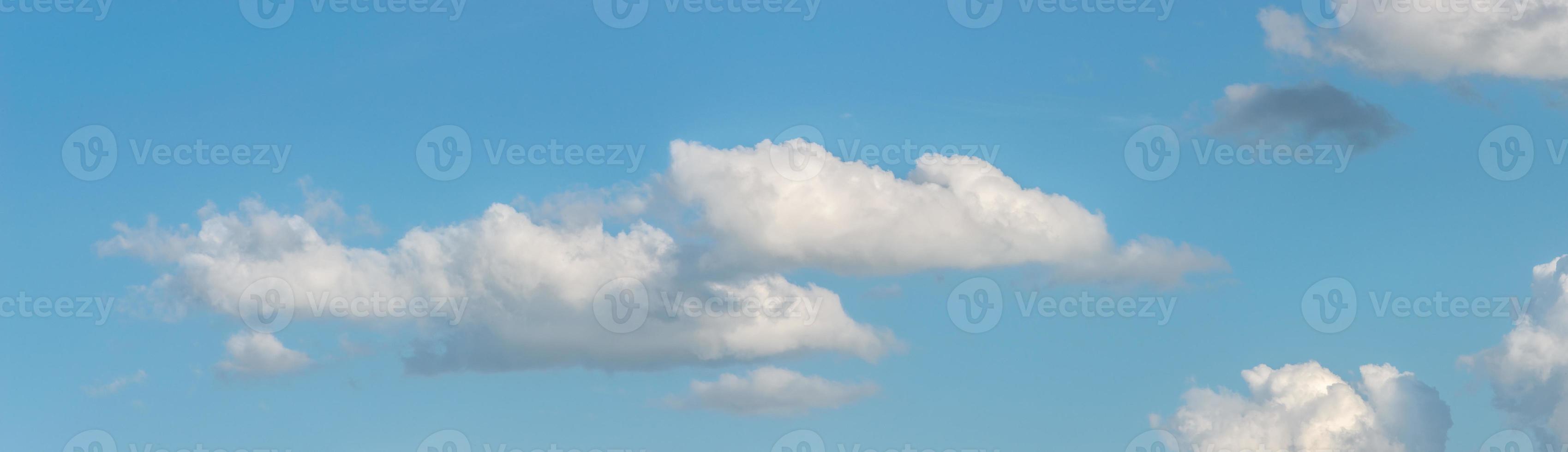Banner with panoramic view over deep blue clean sky with illuminated clouds as a background. photo