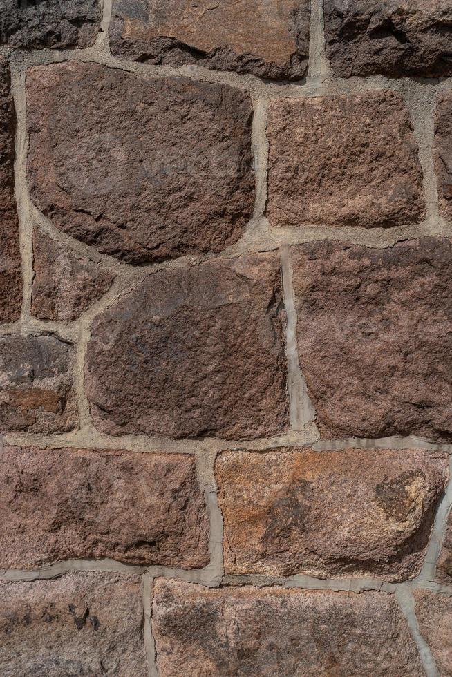 Pattern of ancient bricks and stones at old middle age fortress wall, as a background, closeup, details. photo