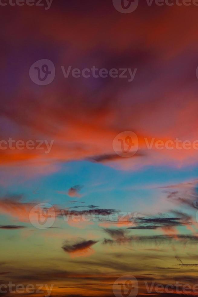 Cover page with deep blue sky with illuminated clouds at bloody sunset as a background. photo