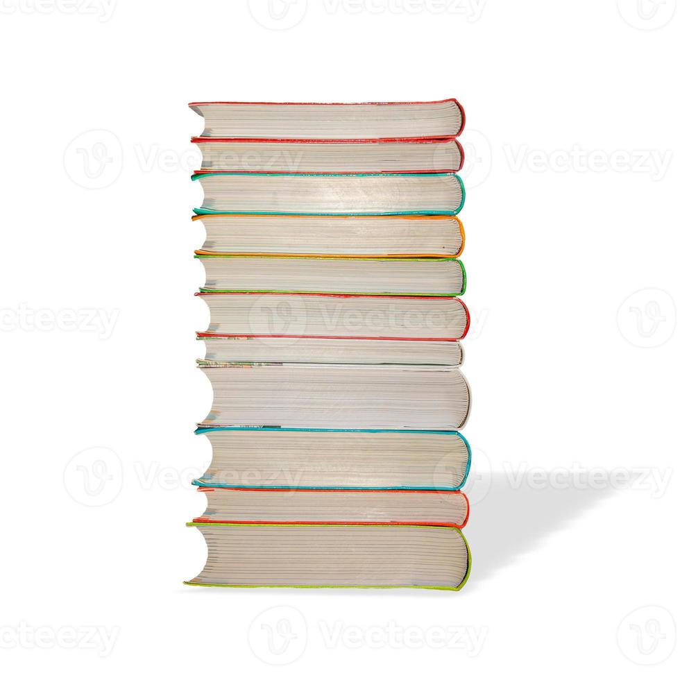 Big pile of colorful paperback books with its shadow isolated at white background. Concept of education, knowledge and paper recycling. photo