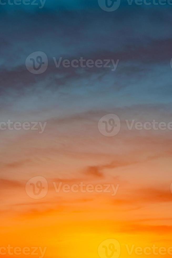 Cover page with deep blue sky with illuminated clouds at bloody sunset as a background. photo