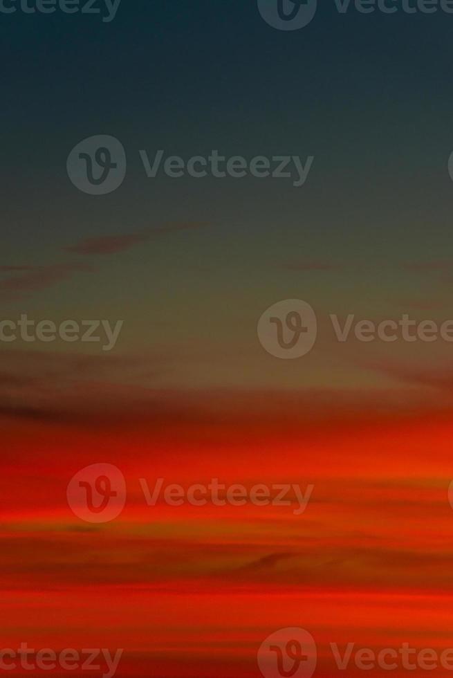 Cover page with gradient soft deep orange sky, illuminated clouds at bloody sunset as a background. photo