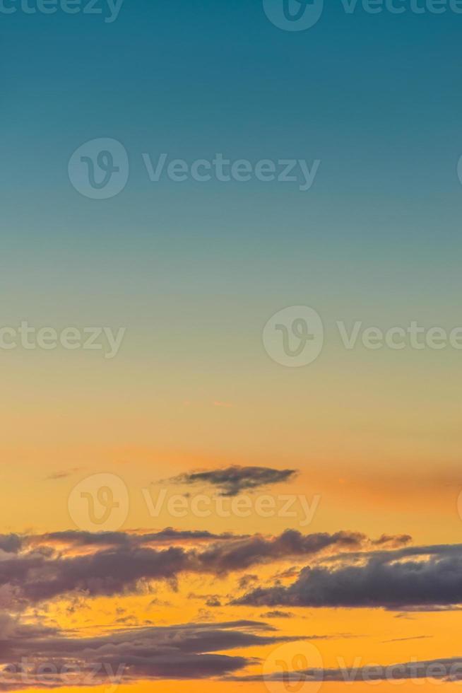 Cover page with gradient deep blue sky, illuminated clouds at bloody sunset as a background. photo