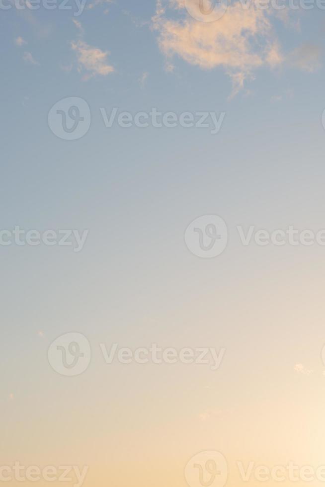 Cover page with gradient deep blue sky, illuminated clouds at bloody sunset as a background. photo