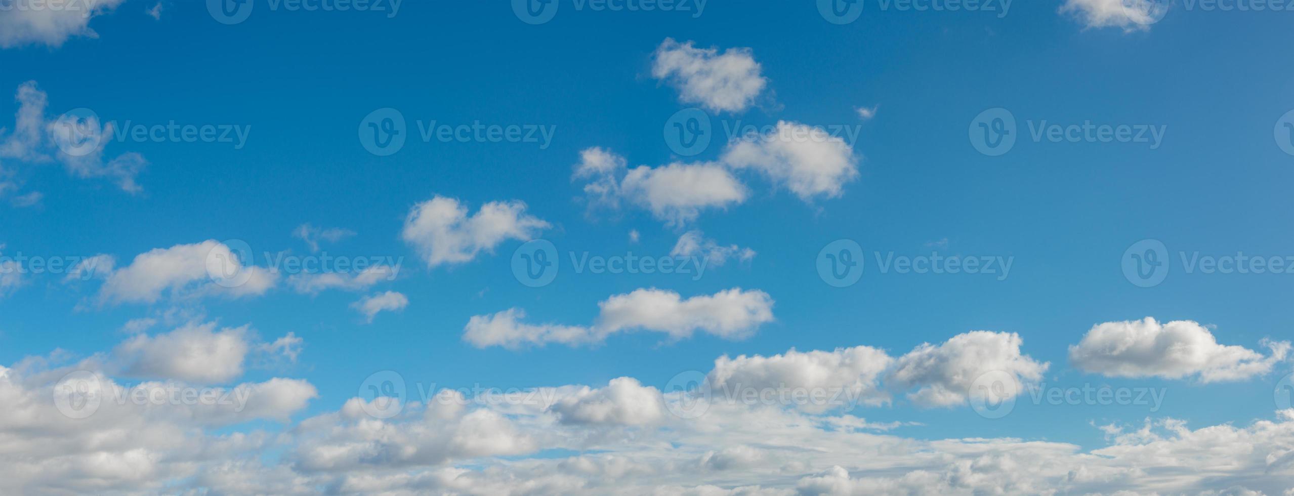 Panoramic view over blue deep sky with clouds as a background with copy space. photo