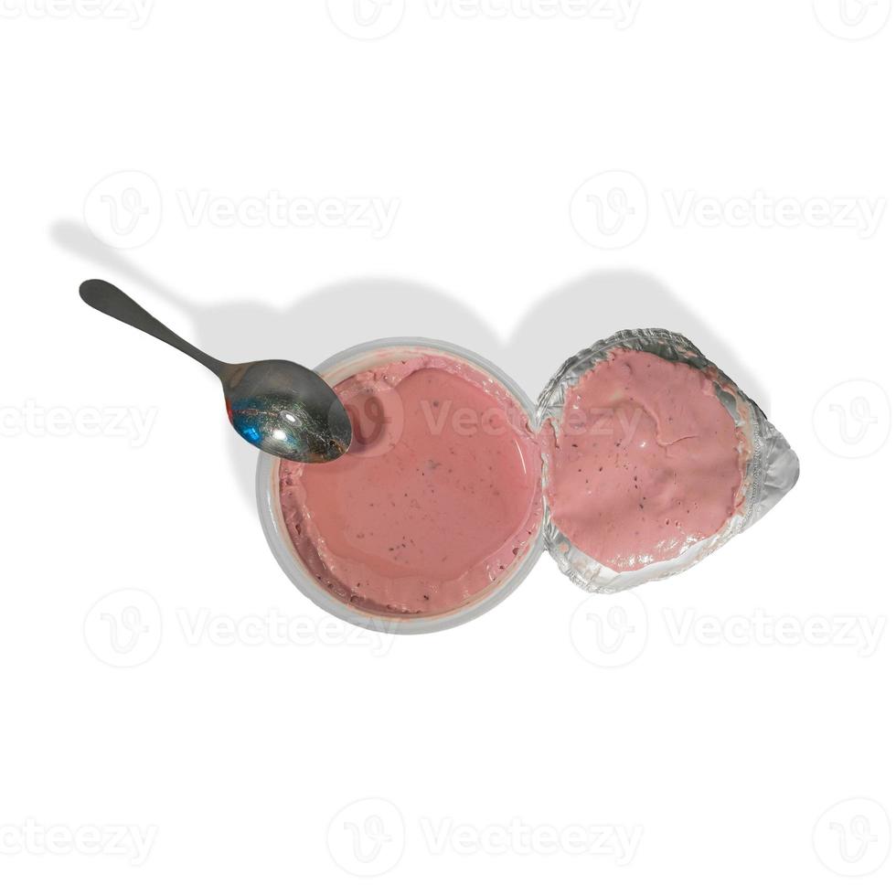 Fruits yogurt in a plastic packaging and a teaspoon isolated at white background. Concept of healthy food, vitamins and healthy life. photo