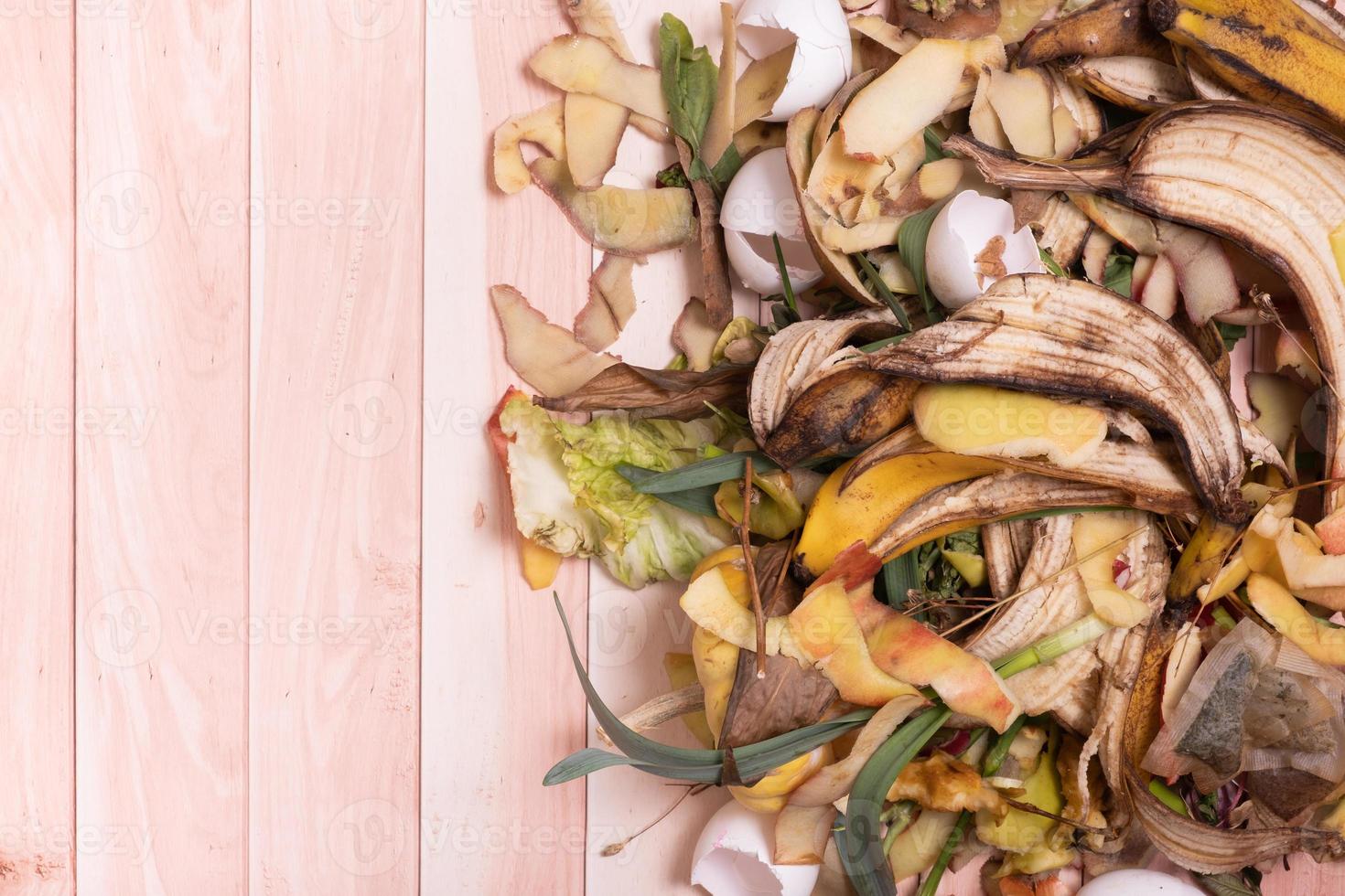 Organic garbage for compost on a wooden background. Composting concept flat lay, top view photo