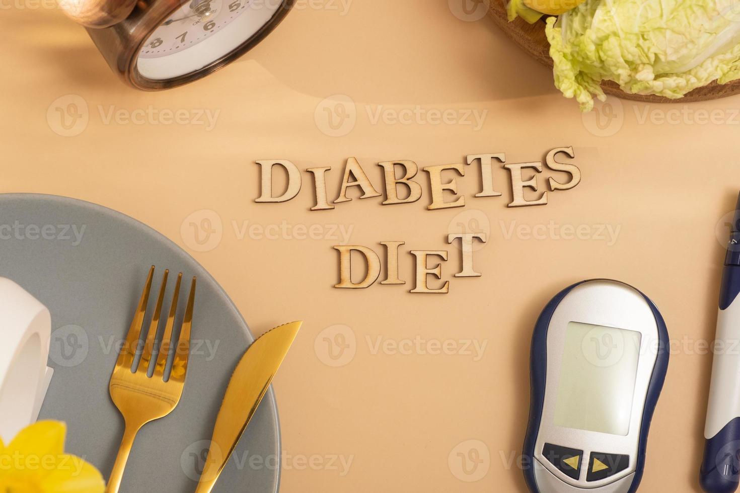 Diabetes diet text with plate and cutlery, glucose meter on beige background flat lay, top view photo