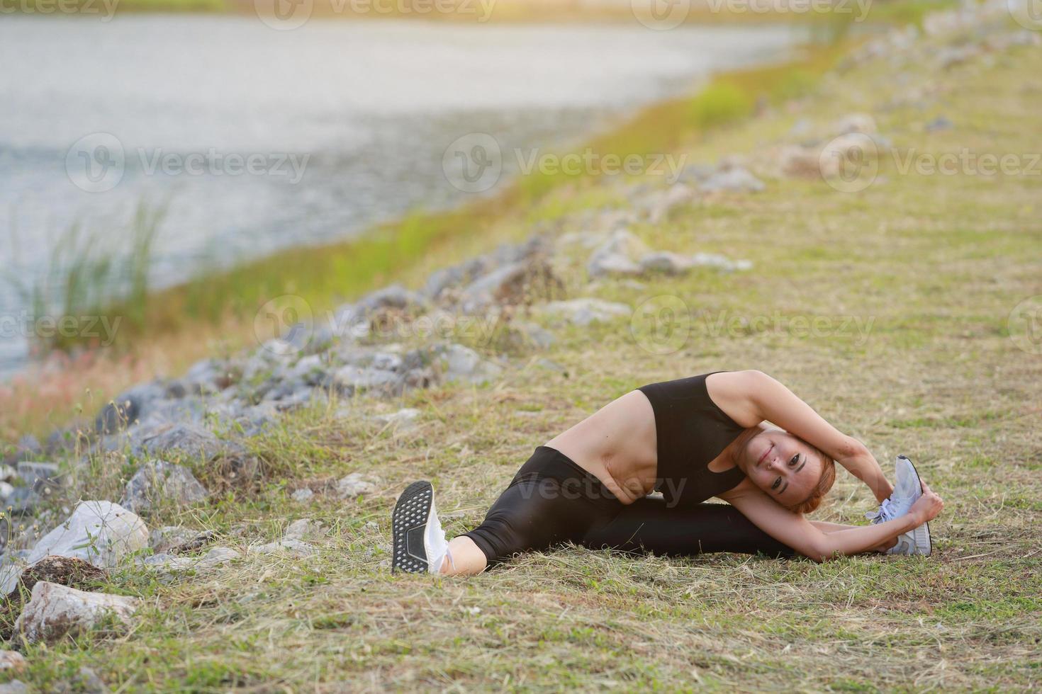 Young girl doing yoga fitness exercise Morning sunrise outdoor in  the meadow beautiful mountains landscape. Meditation and Relax. photo