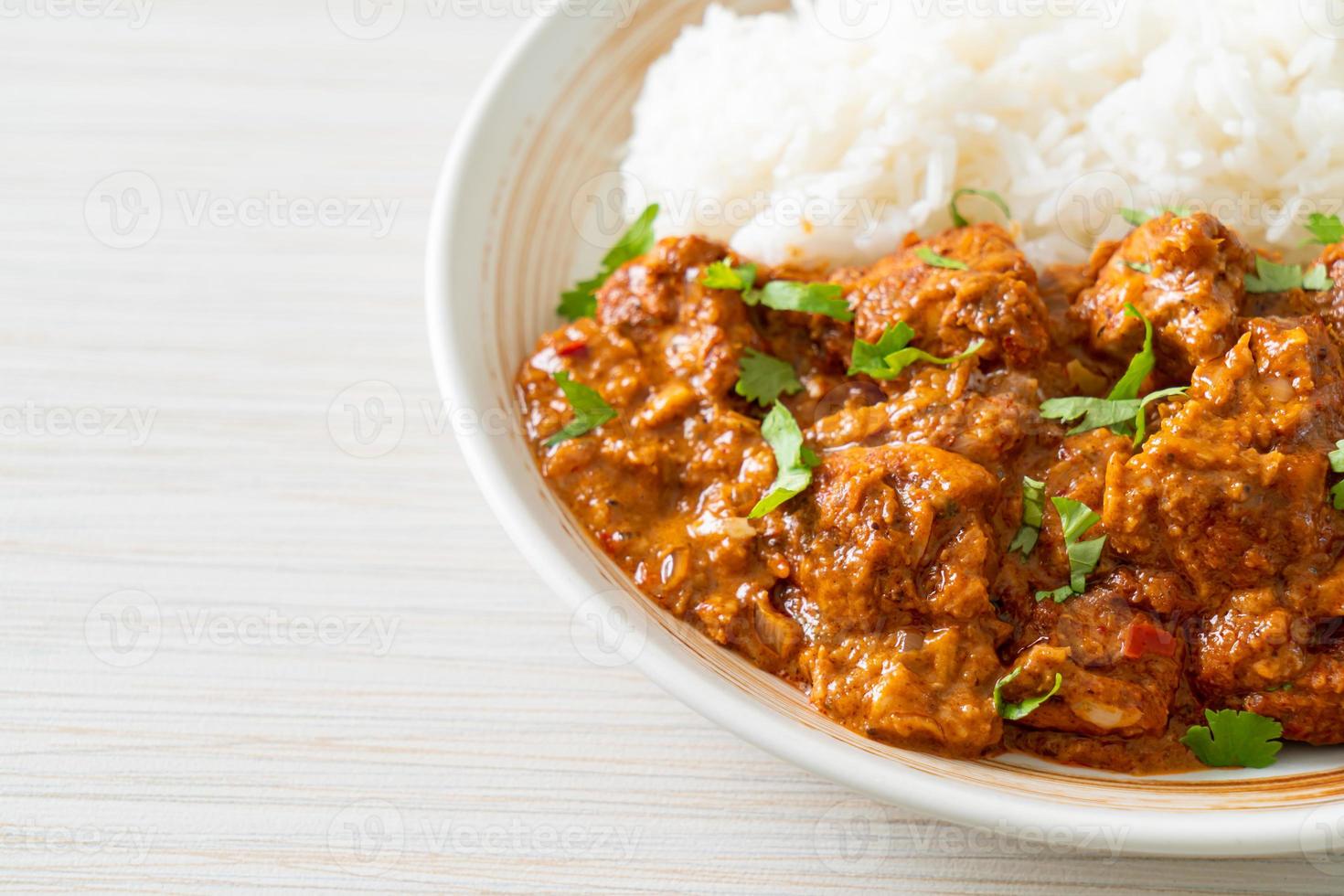 chicken tikka masala with rice on plate photo