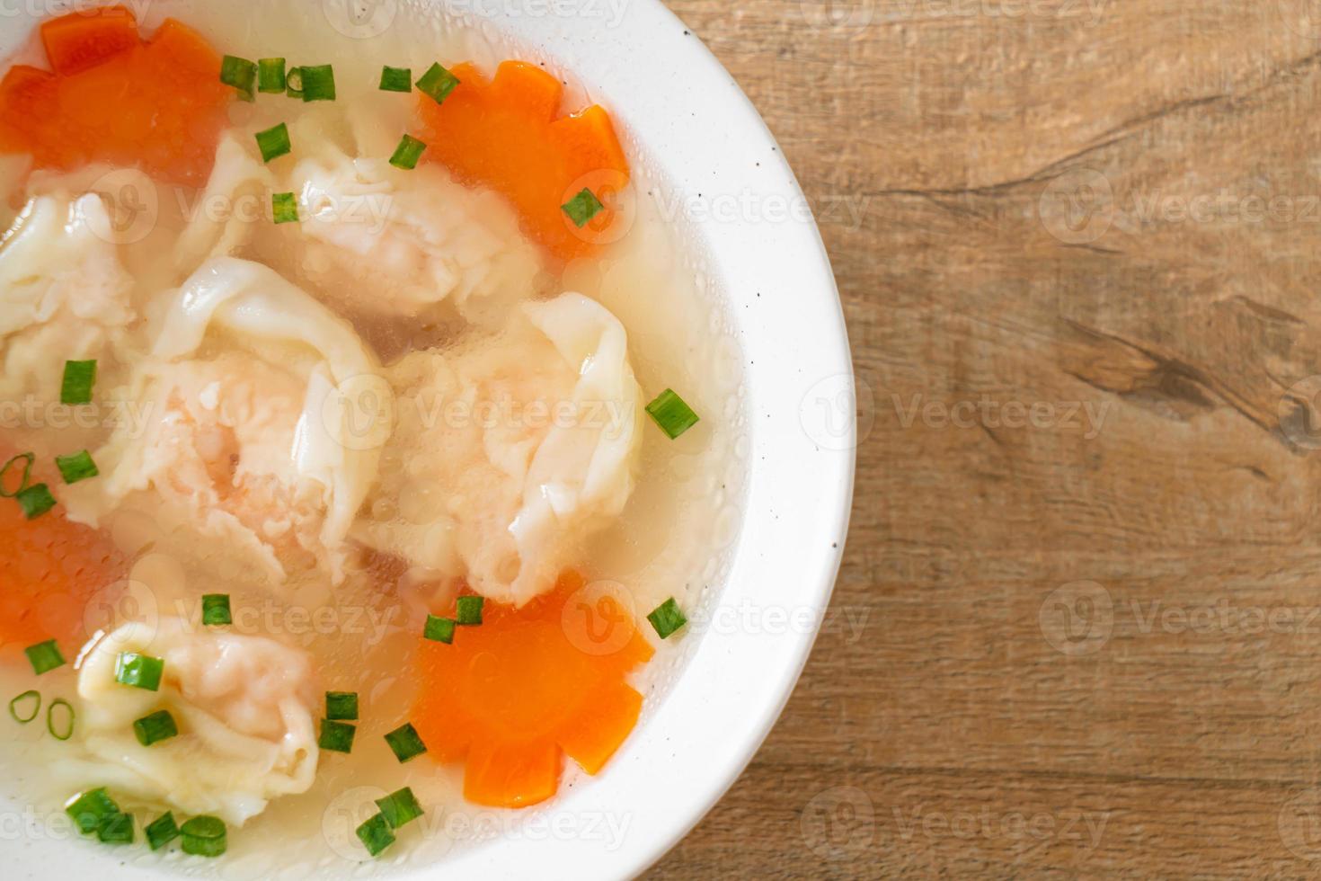 shrimp dumpling soup in white bowl photo