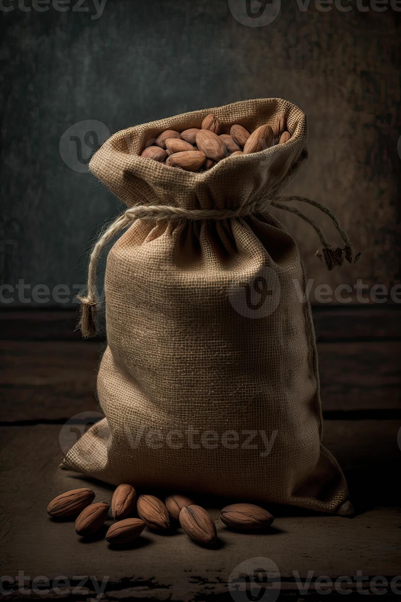 Roasted coffee beans falling in a burlap sack. Sackcloth bag with