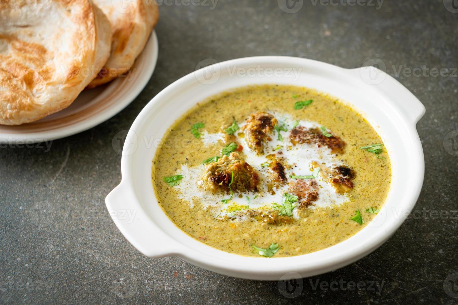 Afghani chicken in green masala curry or Hariyali tikka chicken hara masala with roti or naan bread photo