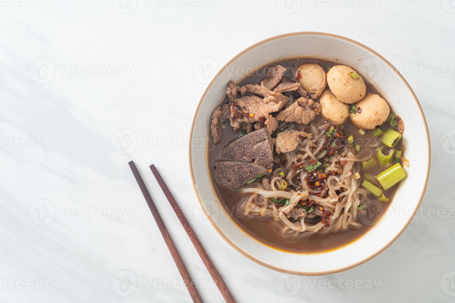 Thai noodle with pork, stewed pork, meatball and pork liver in blood soup photo