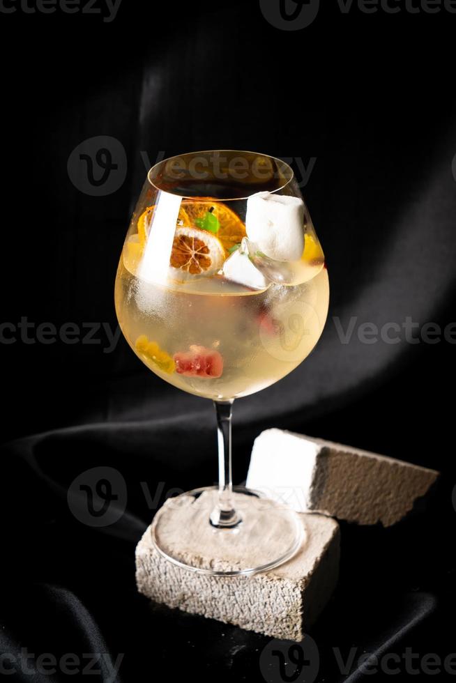 cocktail - white wine, tequila, triple,aromatic bitter, orange bitter, lime juice, syrup, topping with jelly and marshmello and mixed fruits photo