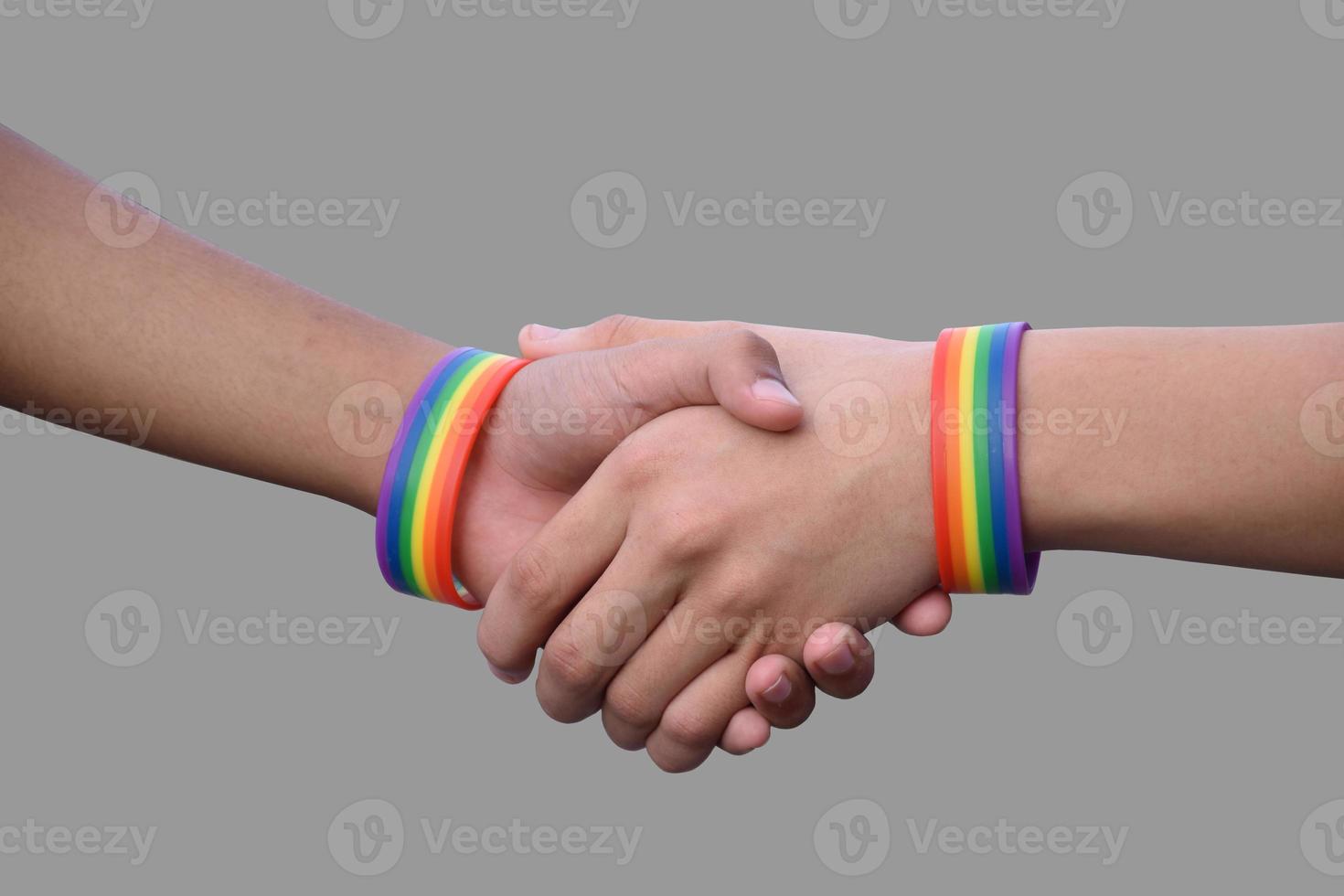 Isolated hands which wear rainbow wristband around them with clipping paths. photo