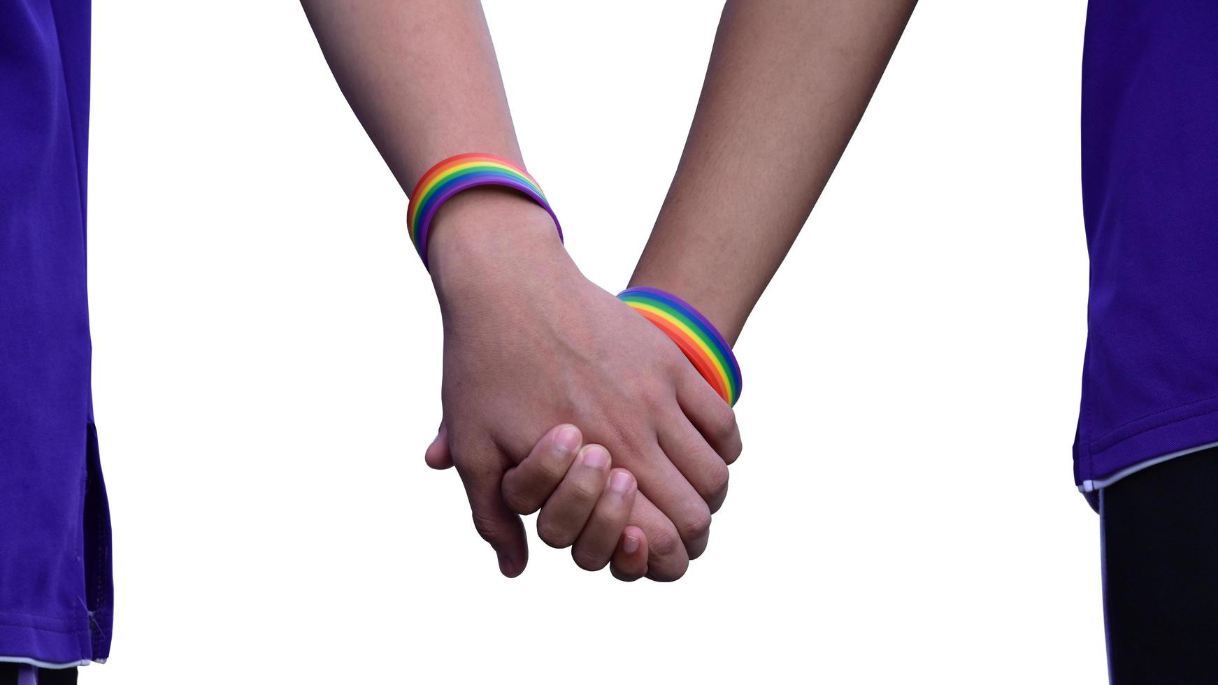 Isolated hands which wear rainbow wristband around them with clipping paths. photo