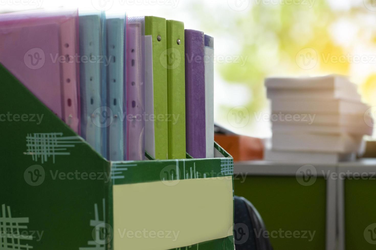 Colorful folders of personnel and office staff are kept and sorted in boxes in the office to evaluate their performance in order to raise their salary or increase their annual remuneration. photo