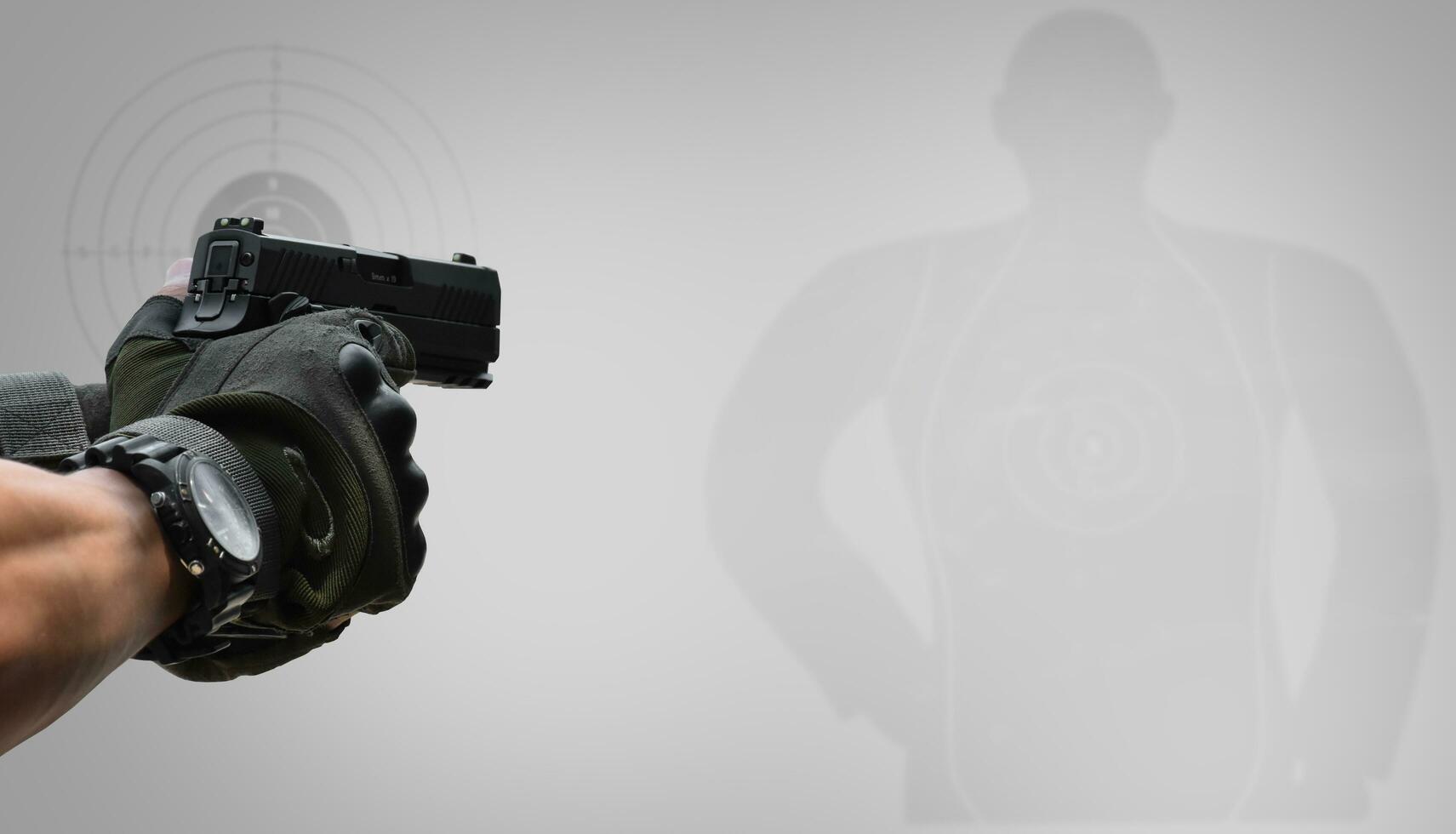 Isolated 9mm pistol gun holding in right hand of gun shooter with clipping paths. photo