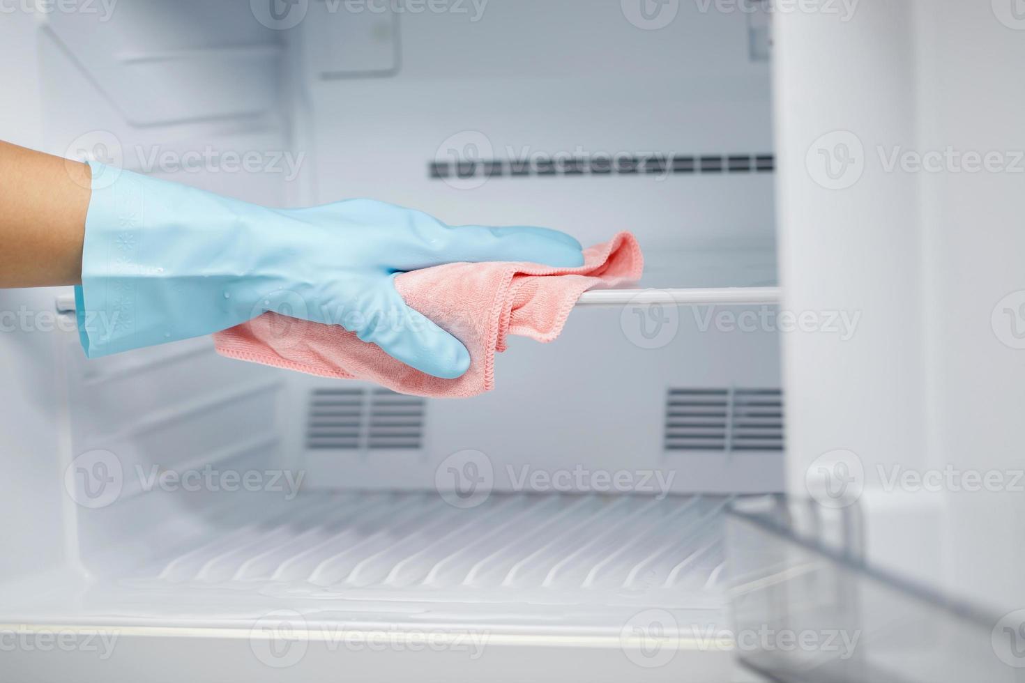 Employees use a cloth to clean the refrigerator. photo