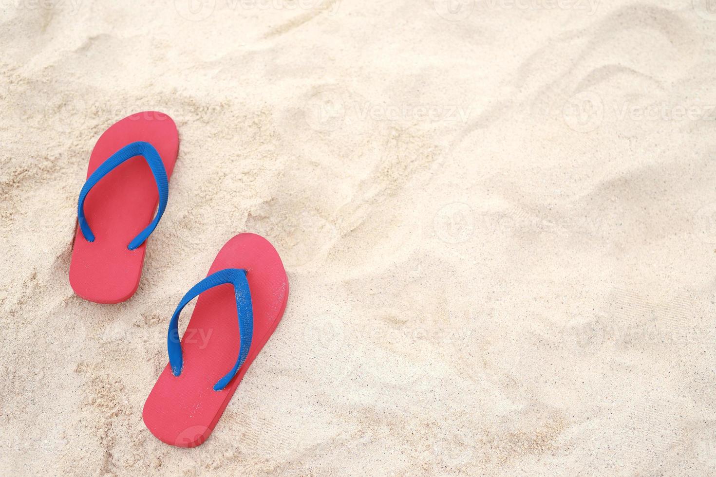 sea on the beach Footprint  people on the sand and slipper of feet in sandals shoes on beach sands background. travel holidays concept. photo