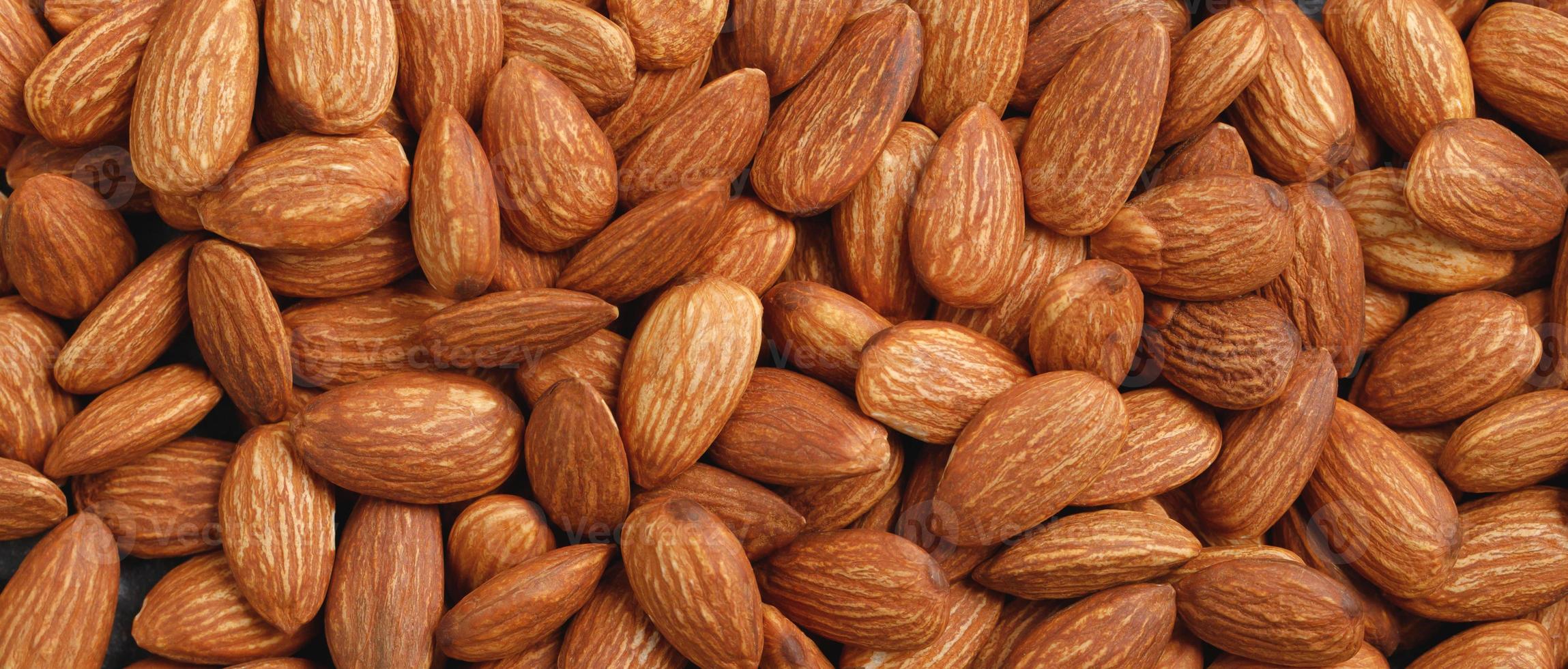 Almonds on a wooden background photo