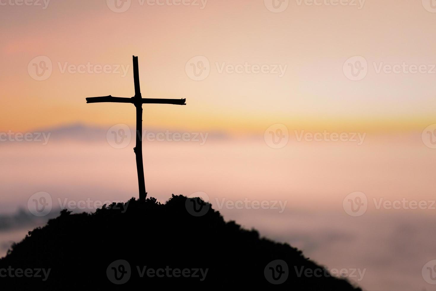 Crucifixion Of Jesus Christ - Cross At Sunset. The concept of the resurrection of Jesus in Christianity. Crucifixion on Calvary or Golgotha hills in holy bible. photo