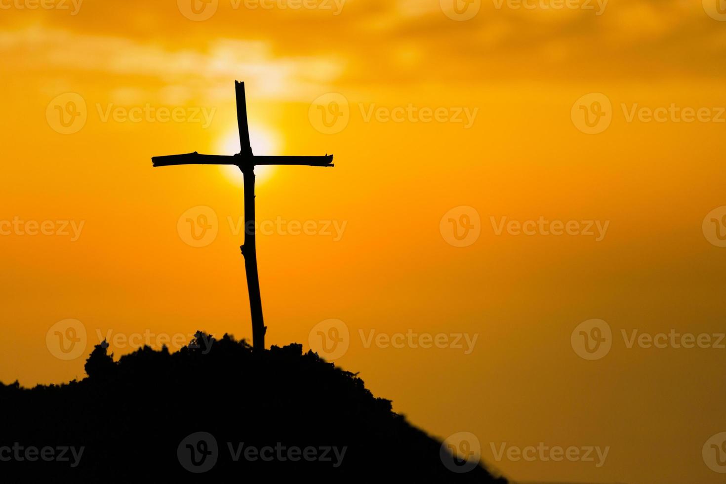 Crucifixion Of Jesus Christ - Cross At Sunset. The concept of the resurrection of Jesus in Christianity. Crucifixion on Calvary or Golgotha hills in holy bible. photo
