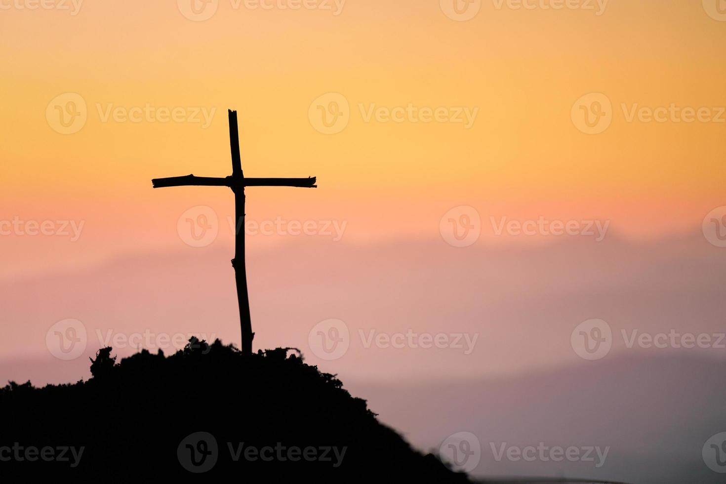 Crucifixion Of Jesus Christ - Cross At Sunset. The concept of the resurrection of Jesus in Christianity. Crucifixion on Calvary or Golgotha hills in holy bible. photo