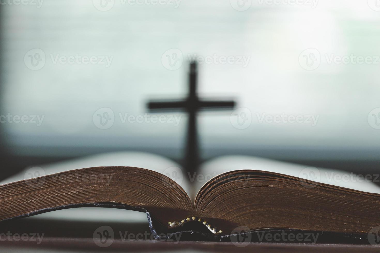 Holy bible book for education on wooden table with background. Christian catholic with protestant worship and pray in church. Concept of learning about faith god and religion, jesus spiritual. photo