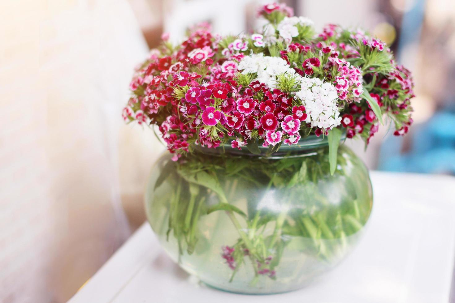 Bouquet Pink Flowers in Glass jar and water in glass vase. photo