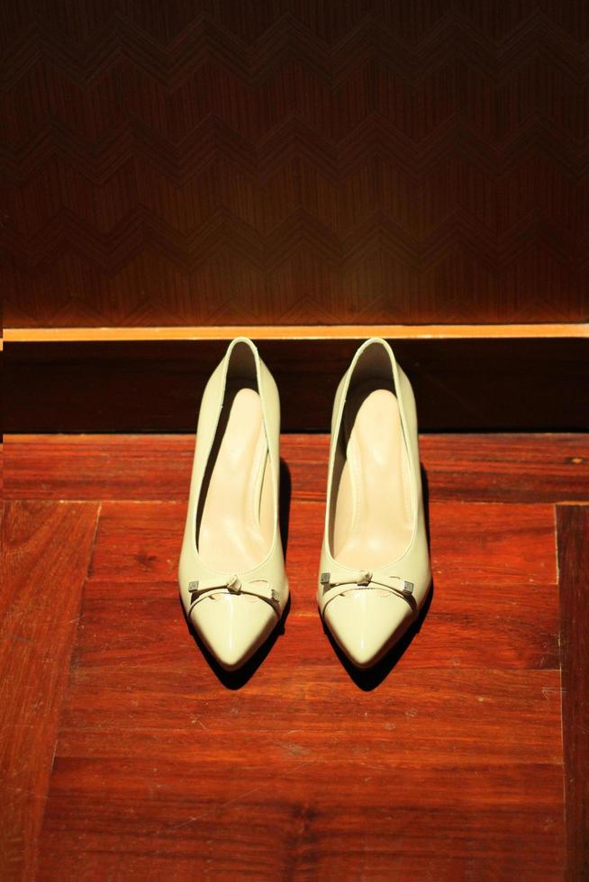 White Footwear for women with thick high heels.Fashion women shoes on wodden floor. photo