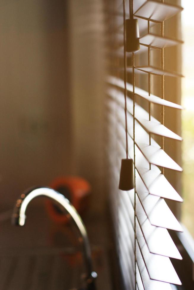 Blind window with warm of sunlighin the kitchen photo