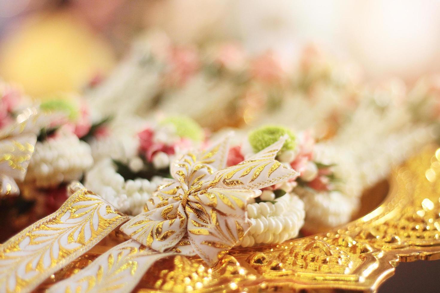 Flower garlands on a gold tray in tradition Thai wedding ceremony day. Jasmine garland. photo