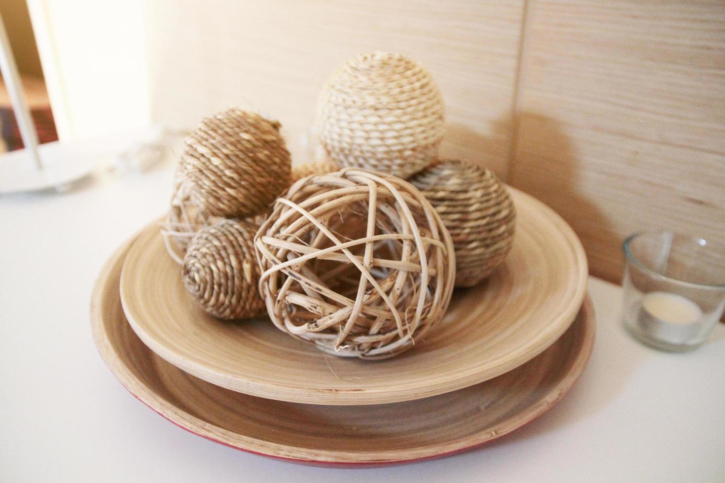 Muzzle weave.Rattan ball decration on ceramic plate. photo