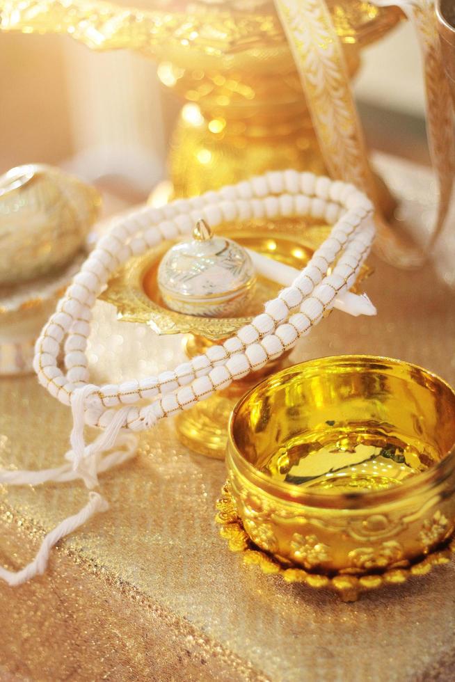 Conch shell on glod tray and Flower garlands on a gold tray decoration on gold bowl for Thai engagement ceremony.Thai wedding culture tradition photo