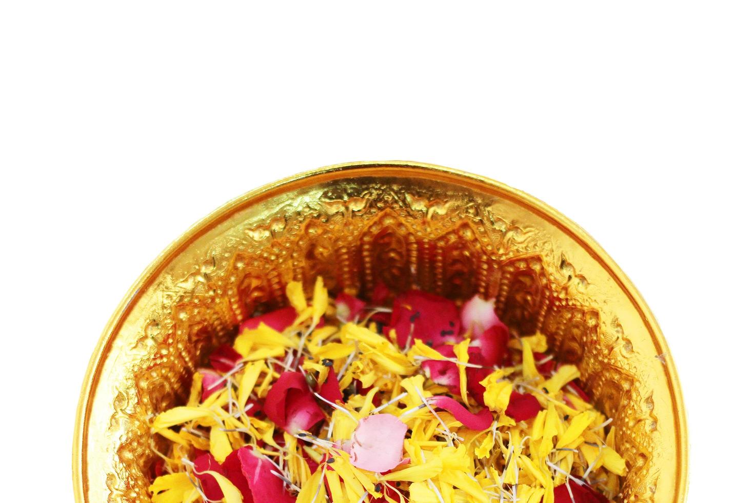 Red rose and Marigold flowers petals in gold tray isolated on white background in tradition Thai wedding ceremony and Buddhism in the temple photo