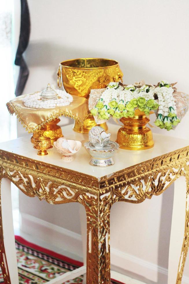 Conch shell on glod tray and Flower garlands on a gold tray decoration on gold bowl for Thai engagement ceremony.Thai wedding culture tradition photo