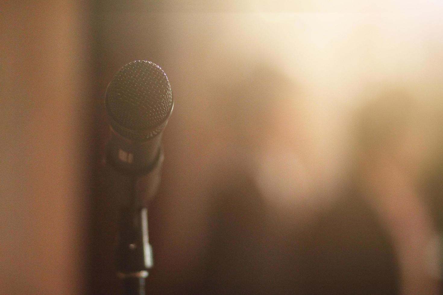 Microphone with light on the stage of music band photo