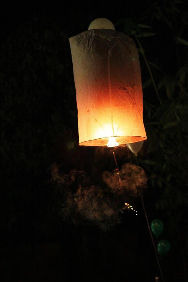 People are launching sky lanterns fire yeepeng is tradition in Floating lantern festival in northern of Thailand photo