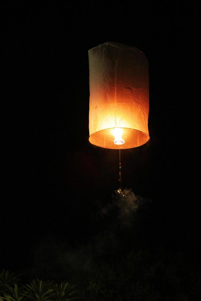 People are launching sky lanterns fire yeepeng is tradition in Floating lantern festival in northern of Thailand photo